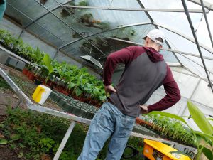 Standing in front of bannanna plants in a green house