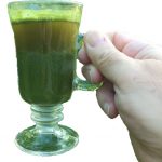 hand holding kratom cup